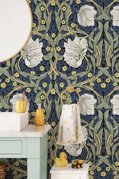 a bathroom with blue and green wallpaper, white sink and yellow rubber ducky toy