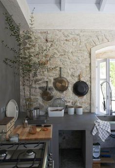 a kitchen with pots and pans hanging on the wall