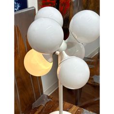 a white lamp sitting on top of a wooden table