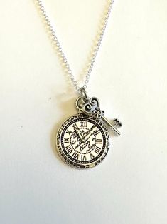 Clock and Key Charm Necklace. Alice in Wonderland inspired double charm with 24 inch necklace. Silver toned finish. Themed Adjustable Silver Charm Necklaces, Clock Locket, Vintage Clock Necklace, Vintage Key Necklace, Clock Necklace, Silver Key Necklace, Key Charm Necklace, Charm Necklace Silver, Christmas Wishlist