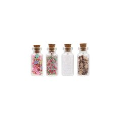 three small bottles filled with different types of candies and sprinkles on top of each other