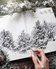 a person is drawing trees in the snow