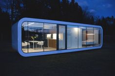 a house made out of shipping containers at night