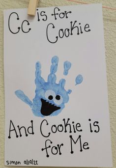 a handprint is hanging from a clothesline with the words c is for cookie and cookie is for me