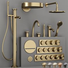 an assortment of gold faucets and shower heads on display in a bathroom setting