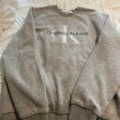 Calvin Klein Jeans Sweatshirt New Without Tags Gray Size L Never Been Worn From Smoke Free Home High End Dry Fit Feel With Reinforced Sewing In Neck Silver Crew Neck Top For Fall, Casual Silver Crew Neck Top, Trendy Silver Crew Neck Tops, Silver Long Sleeve Casual Sweatshirt, Silver Cotton Top For Streetwear, Silver Cotton Tops For Streetwear, Silver Casual Top For Streetwear, Casual Silver Top For Streetwear, Calvin Klein Hoodie