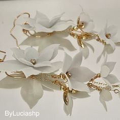 several white flowers with gold chains attached to them