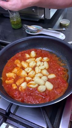 a pan filled with food sitting on top of a stove