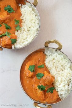 two silver pans filled with rice and chicken curry