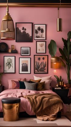 a bedroom with pink walls, gold accents and lots of pictures on the wall above the bed