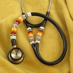 a black stethoscope with an orange and yellow design on it