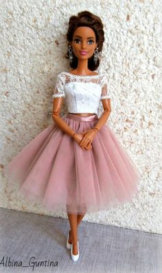 a barbie doll wearing a pink tulle skirt