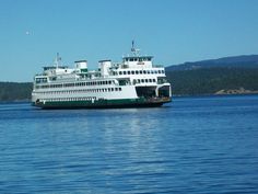 a large white and green boat in the water