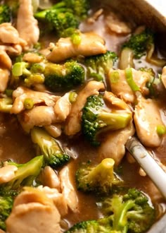 chicken and broccoli in a white sauce with a spoon