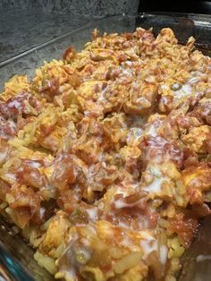 a casserole dish with meat, cheese and sauce on it in a glass pan