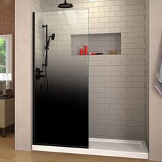 a bathroom with a glass shower door and tiled walls