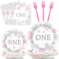 pink and silver snowflake tableware set with one napkin, two plates, fork and utensils