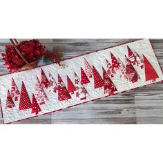 a table runner with red and white christmas trees