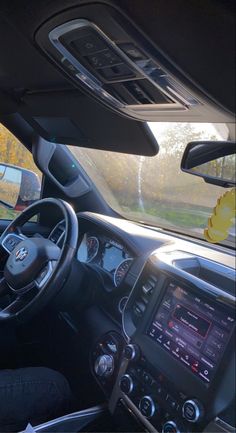 the interior of a car with dashboard, steering wheel and dash board showing on display