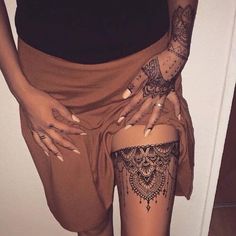 a woman with tattoos on her thigh and leg