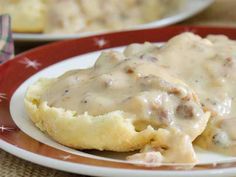 biscuits and gravy on a plate sitting on a table