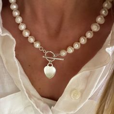 "A beautiful necklace of knitted genuine pearls with a solid sterling heart pendant hanging from  toggle clasp.  An instant classic and great addition to any jewelry collection.  A fantastic gift to give and to receive ❤️ available in 16.5\", 18.5\", 20.5\" lengths.  measurements including the toggle clasp.  heart pendant measures 16 x 20mm, solid 925 sterling silver  the pearls are cultured akoya freshwater pearls, 9-10mm, each will have its own unique variations - no two pearls are the same.  all components are Solid 925 Sterling Silver available without pendant." Elegant Heart Toggle Necklace, Elegant Silver Toggle Necklace With Heart Charm, Elegant Heart Pendant Toggle Necklace For Valentine's Day, Elegant Toggle Necklace For Valentine's Day Gift, Classic Toggle Necklace With Pearl Charm For Gift, Classic Pearl Charm Toggle Necklace, Elegant Heart Pendant Toggle Necklace, Elegant Heart Shaped Toggle Necklace, Silver Toggle Necklace With Pearl Charm Gift