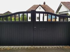 a black gate in front of a house