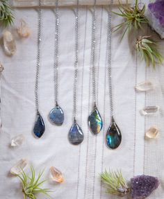 Weather for everyday wear, a special occasion, or to a festival, this piece will be a perfect add to anyones jewelry collection! These tear drop shaped Labradorite necklaces are simply wire wrapped, and hung from stainless steel, hypo allergenic chain & finishings. All of these stones have great coloring and flash. This necklace can be hung at any of the pictured lengths, either 18, 21 or 24, 28 or 32 inches, of your choice. Please refer to last photo.  THIS LISTING IS FOR 1 NECKLACE. Please review photos to select your pennant and length. The photo of the single necklace on the mannequin hangs at 24 inches. The photo of the 3 necklaces hanging from the mannequin displays all 3 lengths.  This piece comes in a lined cardboard box, wrapped in faux vine.  -CRYSTAL HEALING- We have been using Spiritual Teardrop Necklace For Festivals, Bohemian Long Drop Necklace As Gift, Bohemian Teardrop Crystal Necklace For Healing, Handmade Spiritual Teardrop Drop Necklace, Bohemian Teardrop Crystal Necklace For Gift, Nature-inspired Teardrop Necklace For Healing, Bohemian Teardrop Crystal Healing Necklace, Labradorite Gemstone Necklace For Gift, Artisan Labradorite Crystal Necklace As Gift