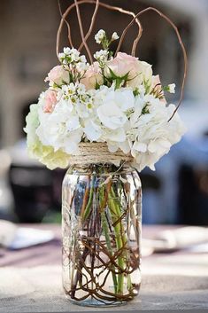 a vase filled with white and pink flowers