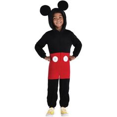 a young boy in mickey mouse costume standing with his hands on his hips and smiling