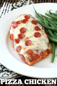 pepperoni pizza and green beans on a white plate