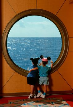 two children looking out at the ocean through a porthole in disney's art of animation