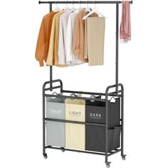 a rack with clothes hanging on it and two bins under the hangers that hold folded towels