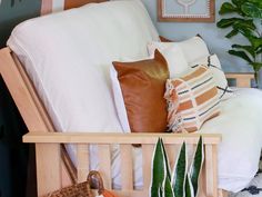 a living room filled with lots of furniture and plants on top of the couches