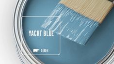 a blue paint can with a wooden brush in it's top and the words yacht blue above it