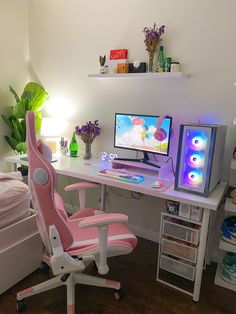 a pink chair sitting in front of a computer desk