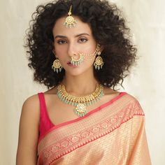 Description: This Kundan bridal set is elegant and beautiful. Encrusted with Kundan stones and a cascade of sea-green beads, this jewelry set is a perfect complement to your wedding or festive look. Crafted in the gold-plated alloy, this necklace comes with matching complimentary embellished Jhumki earrings, nose ring & maang Tikka which can be worn together or as separate pieces. Details & Specifications: Materials used: Brass Alloy with Matte Gold Plating Make it custom Want to make it a custo Kundan Bridal Set, Buy Jewellery Online, Jhumki Earrings, Maang Tikka, Indian Jewellery Design, Traditional Earrings, Festive Look, Kundan Earrings, Indian Earrings