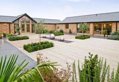 an outdoor courtyard with wooden floors and plants