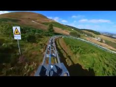 an aerial view of a road in the mountains with a sign on it's side