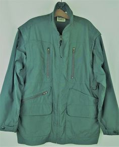 Travel Smith Womens Utility Jacket Hiking Safari Field Convertible Vest Sz L. Travel Smith Women's Utility Jacket - Great for hiking, bush, field, safari, birding - Juniper green (has some blue in it, depending on lighting) - Full zipper down front - Convertible with zip out sleeves, turns into vest - Multi-pockets:   2 Top pockets, vertical zip, 8"D x 4.5"W   4 Bottom pockets; 2 diagonal zip, 7"x10"D x 8"W                                 2 flap with hook & eye, 7"D x 8"W   1 Large back pocket, Winter Utility Jacket With Long Sleeves For Adventure, Functional Green Outerwear With Multiple Pockets, Adventure Utility Jacket With Pockets, Adventure Long Sleeve Utility Jacket With Pockets, Long Sleeve Sport Coat With Pockets For Travel, Vintage Winter Travel Outerwear, Green Long Sleeve Outerwear With Multiple Pockets, Vintage Green Parka For Outdoor, Green Parka With Pockets For Hiking