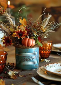 a table topped with plates and vases filled with autumn flowers on top of a wooden table