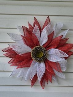 a red and white flower on the side of a building