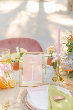 a table set up with place settings and flowers