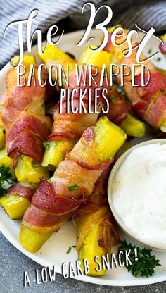 bacon wrapped pickles on a plate with ranch dressing