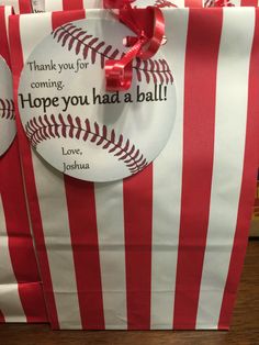 two red and white striped bags with baseballs on them that say, thank you for coming hope you had a ball