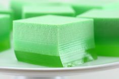 there are many squares of green cake on the plate