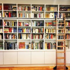 a ladder is standing in front of a bookshelf