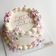 a birthday cake decorated with pink flowers and the words happy mother's day written on it