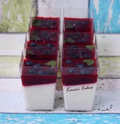 blueberries and yogurt in small containers on a table