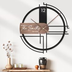 a clock that says the smithy next to a table with vases on it